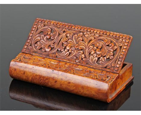 Finely carved 19th Century walnut snuff box, in the form of a book, carved with scrolling leaf swags, 8cm high, 5.5cm wide