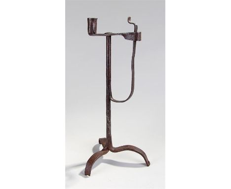 18th Century iron rushnip candleholder, on a tapering column and three legs, 42cm high