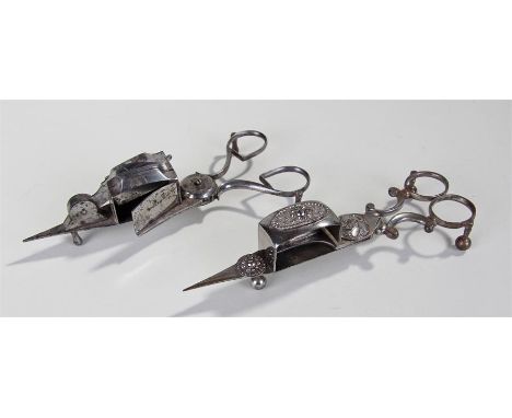 Two pairs of 1820's steel candle snuffers, the first with three steel applied discs, with flower head and geometric dot desig