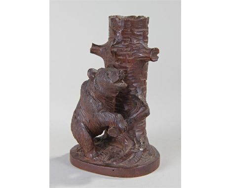 Early 20th Century black forest bear pen holder, the bear holding on to a tree trunk with pen aperture, 16.5cm high