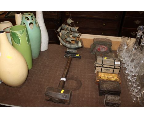 A three masted sailing ship made from a horn; a cast iron gun dog; and a vintage wooden mallet 