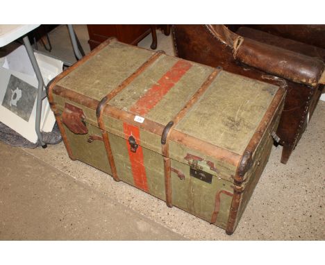 A wooden and metal bound canvas travel trunk bearing labels