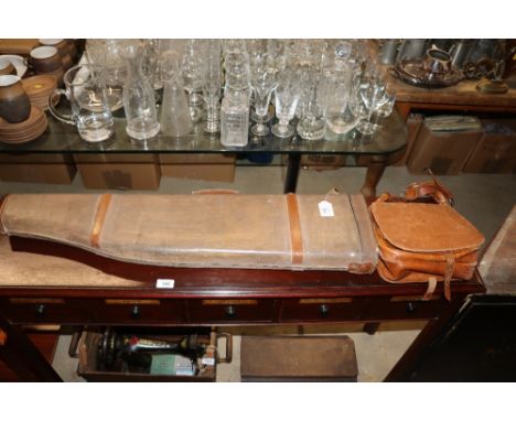 A vintage leather cartridge bag and a leg of mutton gun case