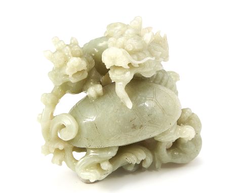 A CHINESE CARVED JADE DRAGON STATUE carved in detail to depict a selection of dragons, 10.2cm, 477g.