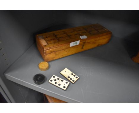 A cribbage box and board with box wood draughts and ebony and bone dominoes