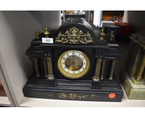 A marble mantel clock with Greek column design