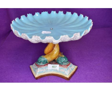 A Victorian table centre supported by three mythical sea creatures and bearing a Royal Worcester stamp to base