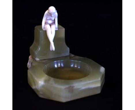 An Art Deco Ferdinand Preiss (1882-1943) carved ivory figure'The Frog Prince' depicting a nude seated girl raised on onyx pli