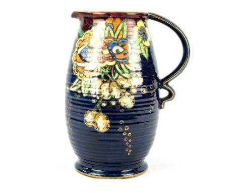 An Art Deco Royal Winton Grimwades jugOf ribbed cylindrical form, with double loop handle, decorated with floral motifs on a 