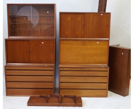 A mid Century Danish teak seven sectional wall unitPossibly by Dyrlund, comprising two chests of drawers, example with two gl