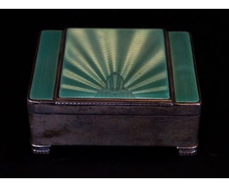 An Art Deco hallmarked silver dressing table boxWith green guilloche enamel cover having an Art Deco motifs and linear decora