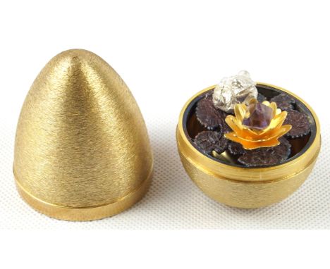 A contemporary hallmarked silver gilt eggBy Stuart Devlin, the cover lifts to enclose a silvered frog and gilt lilly pad, Lon