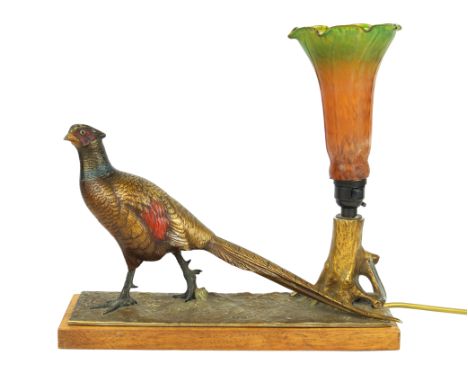 An Art Deco painted spelter desk lampModelled in the form of a pheasant beside a green and orange frosted glass lamp shade, r