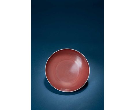 A FINE CHINESE IMPERIAL COPPER-RED GLAZED DISHSIX CHARACTER KANGXI MARK AND OF THE PERIOD 1662-1722The shallow rounded body c