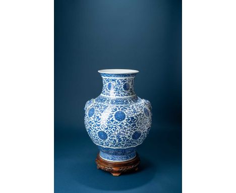 A LARGE CHINESE BLUE AND WHITE HU-SHAPED VASE19TH CENTURY The ovoid body applied with lion mask and moulded ring handles to t