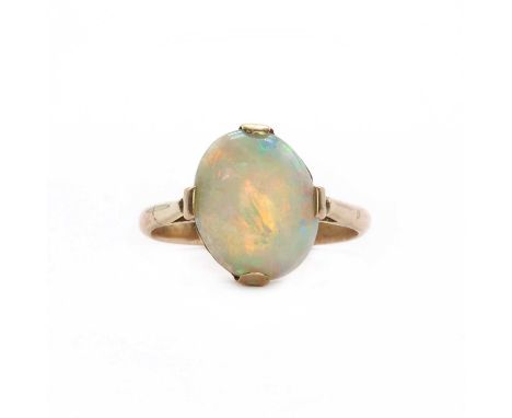 A gold single stone opal ring, c.1930, with an oval cabochon opal, approximately 11.00mm x 8.50mm, claw set to an ornate pier