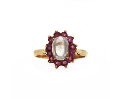 A gold moonstone and ruby cluster ring,an oval cabochon moonstone, claw set to the centre, to a surround of circular cut rubi