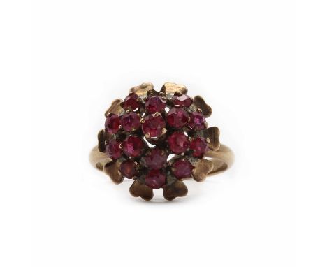 A three tier ruby cluster ring,a circular mixed cut ruby claw set to the top, with a double surround of round mixed cut rubie