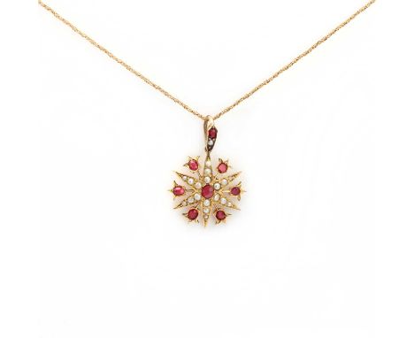 A late Victorian gold synthetic ruby and split pearl starburst pendant,a circular cut synthetic ruby, grain set to the centre