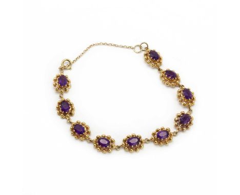 A 9ct gold amethyst bracelet,a row of oval mixed cut amethyst, approximately 5.50mm x 7.50mm, each claw set to belcher collet