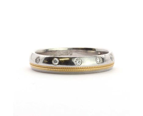 A platinum diamond wedding ring,with brilliant cut diamonds, rub set, to a plain court section band with two rows of gilt pla