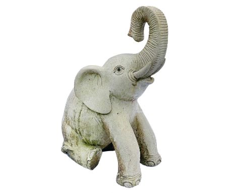 A large composite model of a seated Elephant calf. Height 69cm.