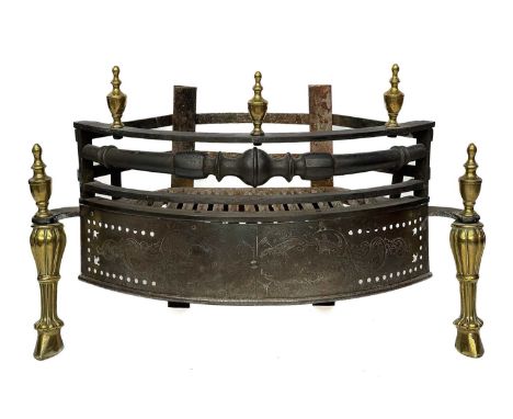 A George III style brass, steel, and iron bow front dog grate. 19th century, with turned brass finials, and rococo scroll and