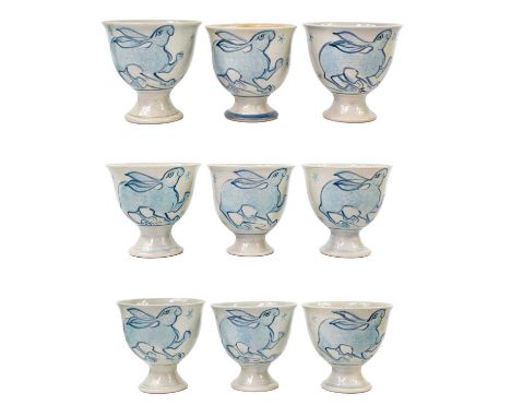 Nine Zane Hazeldine ceramic stem cups.   Painted with hares, 10cm high. (9)