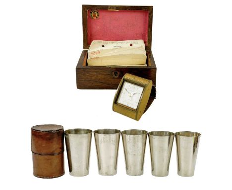 A graduated set of five Army and Navy Ltd silver plated travel cups. In a leather case, together with an Estyma gilt travel c