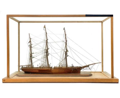 A 19th century scratch built model of the Schooner Carnest. Finely detailed under a glass case, the overall height 42cm width