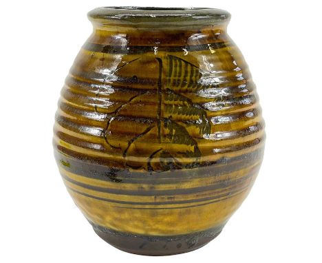 An early Leach studio pottery vase. The ribbed ground with sgraffito type fern decoration, impressed seal mark, height 17.5cm