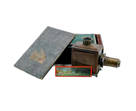 A German E.P tin plate Magic Lantern. With slides in original box.