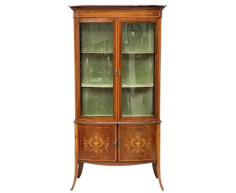 An Edwardian mahogany, satinwood banded and inlaid display cabinet. With slightly bowed front fitted two glazed doors, with t