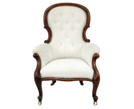 A Victorian mahogany framed button backed upholstered slipper armchair. On ceramic castor wheels. 