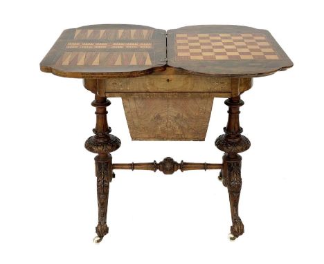 A Victorian burr walnut games and sewing quatrefoil table with boxwood inlay. The fold over swivel top opens to reveal the ch