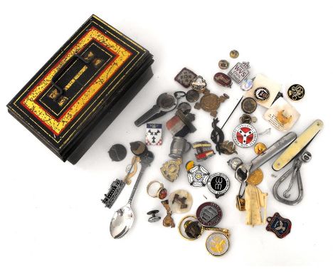 A small tin of enamel badges and other items 