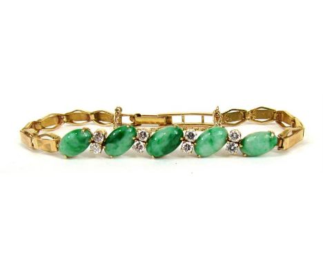 A yellow metal jade and diamond bracelet set with five oval jade cabouchons and eight diamonds.  
