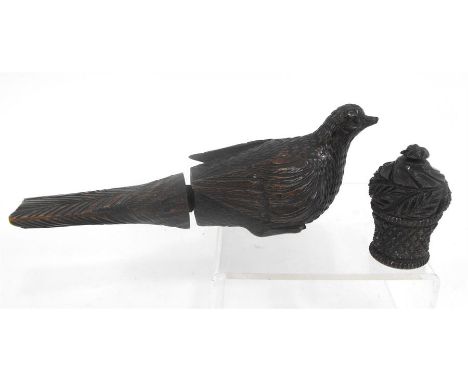 A 19thC black forest nut cracker, in the form of a bird 18cm long and a carved wooden travelling ink well 5cm high 