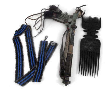 An African hardwood comb, with concentric ring carving 25cm high, a camel whip, and a glass bead work belt (3)