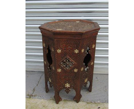 A Middle Eastern octagonal table with mother of pearl inlay, and a camel stool (2)