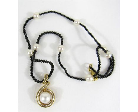 An 18 carat gold, diamond and pearl pendant, the central pearl surrounded by channel set baguette diamonds on a black diamond