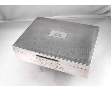 A silver table cigarette box, Birmingham 1940, with military inscription, "2nd Lieut. A. M. Watts from the officers 6th BEN. 