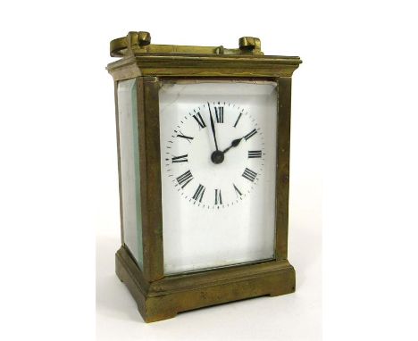 A Brass cased carriage time piece, the enamel dial having Roman numerals 12cm high  