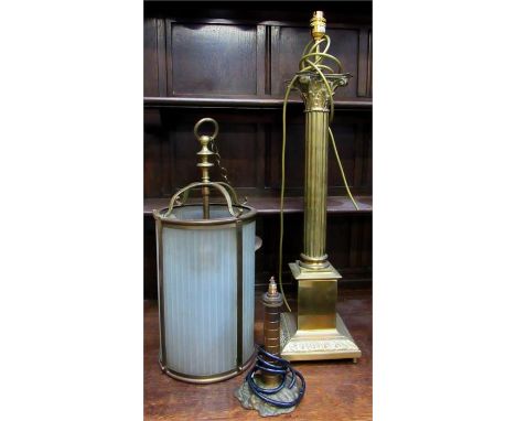 A large brass Corinthian column table lamp, 73cm high, a brass hall lantern 52cm high, and a brass table lamp in the form of 