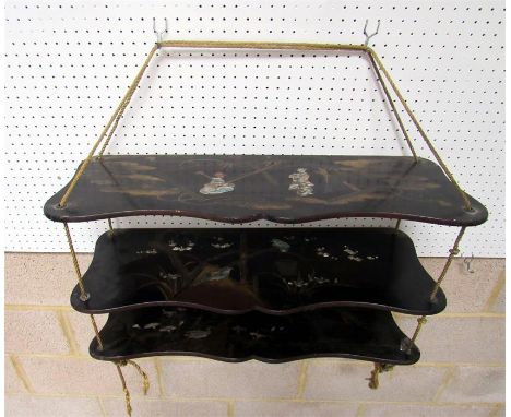 A Japanese lacquer three tier wall shelf, inlaid with mother of pearl and decorated birds 67cm wide 