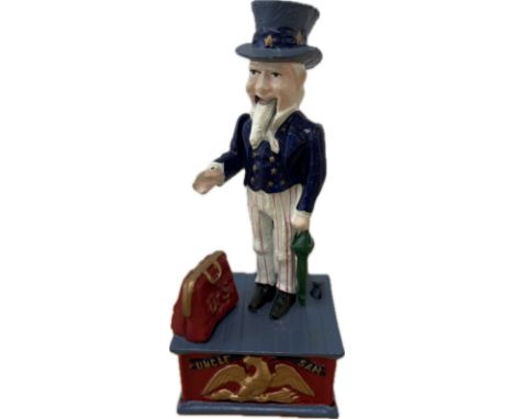 A painted cast iron mechanical "Uncle Sam" money box, push button action, the arm moves to drop the coin into the opening bag