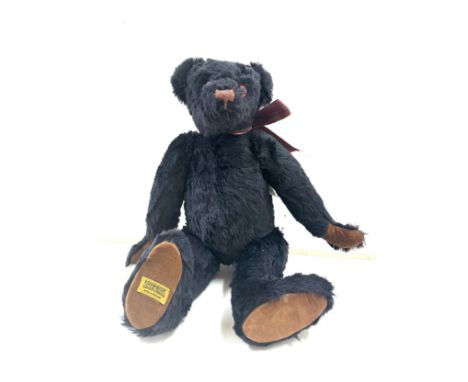Large black merrythought bear label to foot, approximately 50cm tall