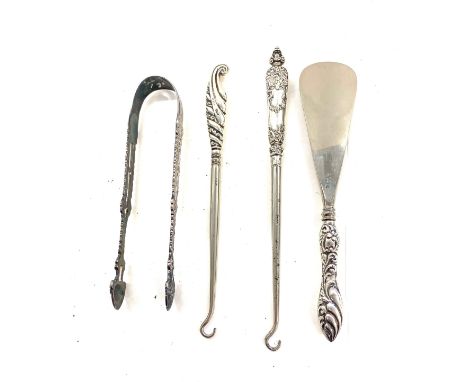 Early pair of sterling silver sugar tongs and button hooks with silver handles and shoe horn 