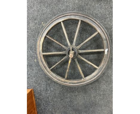 Vintage wooden cart wheel measures approximately 26 inches diameter 