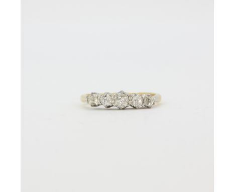 An antique 18ct yellow gold and platinum (worn stamp 18ct) ring set with five graduated old cut diamonds, (O.5).